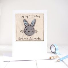 a happy birthday card with a rabbit on it and some tape next to it,