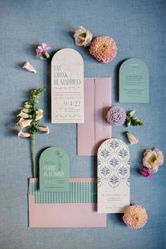 the wedding stationery was done in pastel colors and with flowers on each side