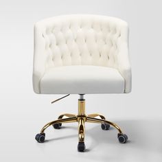 a white office chair with gold wheels and casteors on an upholstered surface