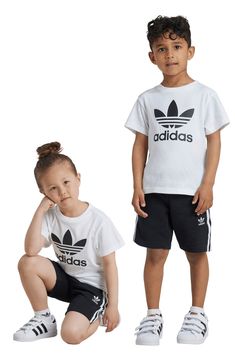 A bold Trefoil design dominates a kid-sized T-shirt that's paired with matching shorts finished with signature 3-Stripes racing down the sides. Shorts have elastic/drawstring waist; side-seam pockets 70% cotton, 30% recycled polyester Machine wash, tumble dry Imported Adidas Cotton Shorts With Three Stripes Branding, Adidas Logo Cotton Shorts For Summer, Adidas Cotton Shorts With Three Stripes, Adidas White Shorts With Logo, White Adidas Shorts With Logo, Adidas Casual Tops For Playwear, Casual Adidas Tops For Playwear, Adidas Kids, Size 4t