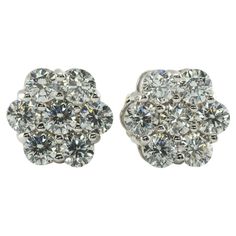 Diamond Earrings Studs 14K White Gold Cluster 1.12 TDW This pair of diamond cluster studs is crafted in solid 14K White Gold. There are seven natural round brilliant cut diamonds totaling 1.12 carats for the pair. The diamonds are VS2-SI1 clarity and HI color. The earrings are equipped with long posts and butterfly backings. The top of the earrings measures 9mm. The earrings weigh 2.7 grams. Great estate condition. Dazzling Cluster Diamond Earrings For Formal Occasions, Dazzling Cluster Diamond Earrings For Formal Events, Luxury Brilliant Cut Cluster Earrings For Anniversary, Formal White Gold Cluster Earrings, Luxury Cluster Diamond Earrings With Single Cut Diamonds, Luxury Cluster Diamond Earrings For Anniversary, Formal Cluster Diamond Earrings With Brilliant Cut, Formal Vvs Clarity Diamond Cluster Earrings, Formal Cluster Earrings