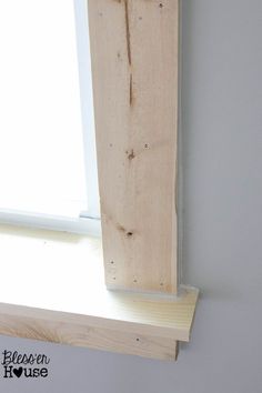 the corner of a window sill that has been made out of wood