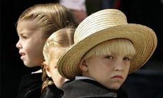 two young children wearing hats sitting next to each other