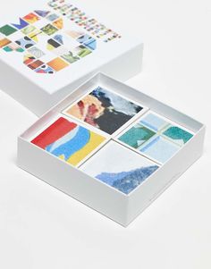 an open box with four different pictures in it on a white surface and the lid opened