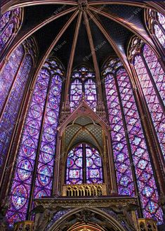 the inside of a cathedral with stained glass windows