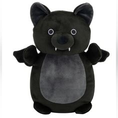 a black stuffed animal with big eyes and an angry look on it's face