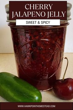 cherry jalapeno jelly in a jar next to a cucumber