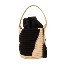 The Coba Basket Bag is the perfect carry-all for your personal items or toting a favorite bottle of rose' to the beach. The tote has a natural leather handle, a black cotton drawstring lining to secure your belongings and is finished off with a black leather tassel. It's natural style all the way from city to beach. Made from raffia, nylon and cow leather Measures: 7"H 6"W (not including handle) Chic Black Straw Bag, Black Travel Shoulder Bag With Bamboo Handle, Black Shoulder Bag With Bamboo Handle For Travel, Casual Black Bag With Bamboo Handle, Black Bucket Bag With Braided Handles, Black Straw Bag With Bamboo Handle For Travel, Black Straw Tote Bag With Bamboo Handle, Black Vacation Bag With Bamboo Handle, Chic Bucket Bag With Bamboo Handle For Everyday