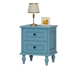 a blue night stand with two drawers and a lamp on the end table next to it