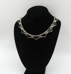 Originally $475.00.  Vintage Mexican Necklace with Black Onyx inlayed in Sterling Silver.  This necklace is a dream to wear and is of excellent craftsmanship: The hinged design allows this necklace to lay beautifully just like a collar that fits well around the neck.   The inner circumference is 16 3/4 inches It is stamped "Mexico"  and 925 The condition is excellent with minimal wear. Formal Onyx Necklace With Polished Finish, Formal Onyx Necklace With Black Enamel, Black Enamel Necklace For Evening, Vintage Black Necklace For Formal Occasions, Black Vintage Necklace For Formal Occasions, Formal Silver Onyx Necklaces, Art Deco Evening Jewelry With Polished Finish, Vintage Black Enamel Necklaces For Evening, Vintage Black Enamel Necklaces For Formal Occasions