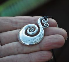 Hand crafted New Zealand Maori koru design in Solid 925 Sterling silver. A sculptural piece that is fully shaped on the front & the back. It has a smooth highly polished finish and engraved Maori design. It measures 1.7 inches long or 4.3cm and 1.1 inch wide. The Maori koru is a treasured symbol in New Zealand, it represents nature and symbolises new beginnings & spiritual growth bringing renewal & inspiring new ideas & adventures. The fine koru detail on the top symbolises love Nature Symbols, Maori Designs, Love Symbols, Love Design, Solid 925 Sterling Silver, Sterling Silver Chains, New Zealand, Rings For Men, Silver Rings