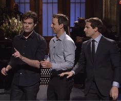 three men in suits are talking to each other on the set of late night with jimmy stewart