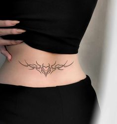 a woman's stomach with an intricate tattoo design on her lower back and side