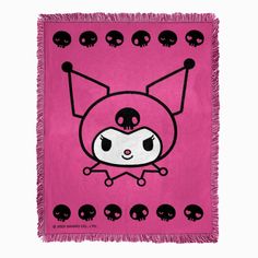 a pink blanket with black skulls on it and a cartoon character in the center,