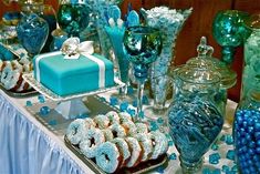 a table topped with lots of blue and white desserts