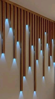 a bathroom with wooden slats and blue lights on the wall next to the sink