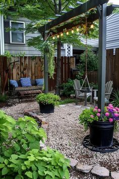 an outdoor patio with potted plants and lights strung from the pergolated arbor