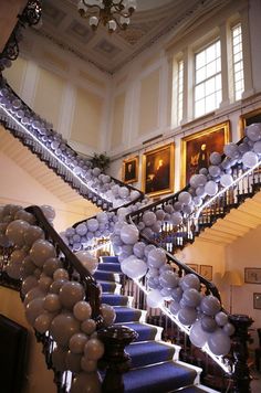 black and white photograph of staircase with balloons