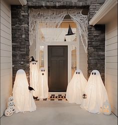 halloween decorations are on display in front of a home's entryway, decorated for the holiday season