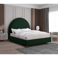 a bed with green headboard and foot board