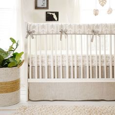 a white crib with a plant in the corner