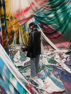 a woman is standing in front of an art installation that looks like it has been painted