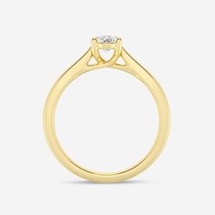 a yellow gold engagement ring with a single diamond on the top and side stones in the middle