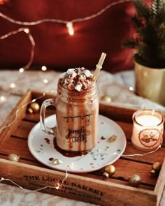 a drink in a mason jar with sprinkles on it sitting on a tray