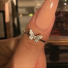 a woman's hand with a diamond ring on it