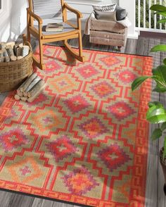 an outdoor area rug with a rocking chair and potted plant on the porch next to it