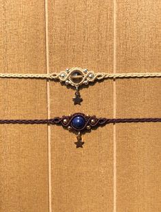 a close up of a piece of cloth with beads and chains attached to it on a wooden surface