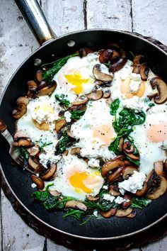 mushrooms, eggs and spinach in a skillet