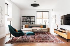 a living room filled with furniture and a flat screen tv