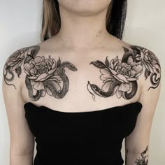 a woman with tattoos on her chest and shoulder