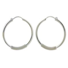 Exploring silver textures Wadarat Supasirisuk wraps a sterling twist around gleaming hoops. The result is a pair of striking earrings with timeless appeal handcrafted in sterling silver (0.925). Silver Spiral Hoop Earrings For Everyday, Everyday Spiral Silver Hoop Earrings, Everyday Silver Hoop Wrap Earrings, Everyday Silver Spiral Hoop Earrings, Silver Hypoallergenic Hoop Wrap Earrings, Modern Wire Wrapped Hoop Earrings, Small Silver Wire Wrapped Hoop Earrings, Sterling Silver Wire Wrapped Hoop Earrings, Modern Silver Wire Wrapped Hoop Earrings