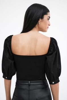 Our Alana Top is an ode to love. A day-to-night romantic look, her fitted bodice in high-stretch and sustainable European jersey features a square neck that gracefully frames your face and neck, while billowy mid-length sleeves in European poplin cotton are punctuated by mother-of-pearl button cuffs for a poetic finish. Sister to our Shira Top Alana's double-layered for comfort and support.[SPLIT] Sam, in black, is 5'8" (173 cm) tall, wearing size XS. Shannon, in off white, is 5'8" (173 cm) tall Tunic Hoodie, Top Clothing, Mid Length Sleeves, Romantic Look, Mother Of Pearl Buttons, Fitted Bodice, Tunic Dress, Love A, Mid Length