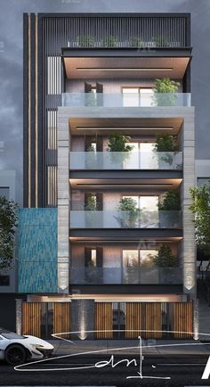 an apartment building with balconies and plants on the top floor is lit up at night