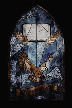 a stained glass window with an eagle and banner