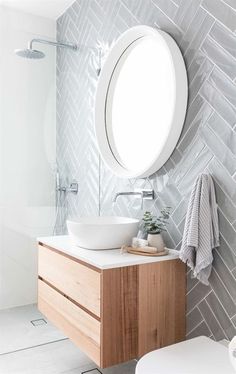 a bathroom with a sink, mirror and toilet