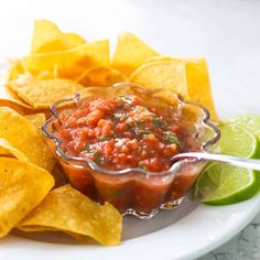 a white plate topped with chips and salsa