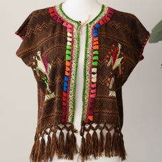 This beautiful traditional Mexican Huipil - blouse is hand made and embroidered by  women artisans from San Juan Chamula Chiapas. The embroidery style is called "Milpita" which shows corn leaves in different colors, and sometimes figures of farmers working on the field, just beautiful hand embroidered details. Unique item,no other like it!  Details: - Cotton - 24 " front length, (including fringes) - 18" back length  - Size: ONE SIZE (Can fit small, medium,and large) - Open front - All items shi Bohemian Blouse With Woven Motifs For Festivals, Brown Embroidered Festival Top, Embroidered Brown Tops For Festival, Bohemian Embroidered Top With Multicolor Motif, Bohemian Tops With Motif For Festival, Multicolor Folk Tops With Woven Motifs, Bohemian Blouse With Woven Motifs, Folk Style Festival Tops With Woven Motifs, Folk Style Multicolor Tops With Woven Motifs