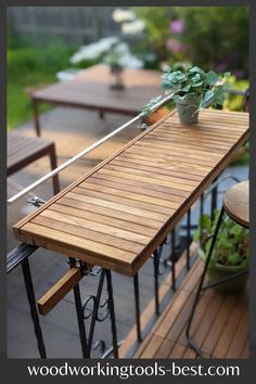 an outdoor table with potted plants on it