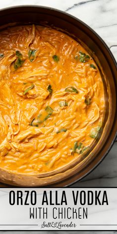 a bowl of orzo alla vodka with chicken in it on a marble counter top