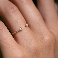 Twin sparkling white sapphires cap each end of this textured open band ring. Lovely on its own and stacks beautifully with our other rings, especially our Daybreak Ring. Inspired by the roots of the Banyan tree, our signature texture is a symbol of strength, growth, and self-awareness. Solid gold, always — in your choice of 9k or 14k. Dainty Single Cut Diamond Promise Rings, Dainty 14k Gold Bypass Promise Ring, Dainty 14k Gold Open Bypass Ring, Dainty Open Ring With Single Cut Diamonds, Dainty Rings With Single Cut Diamonds, Delicate Stackable Open Diamond Ring, Dainty 14k Gold Bypass Ring, Single Cut Diamond Stackable Open Rings As Promise Ring, Dainty Diamond Ring With Si Clarity