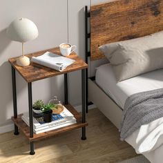 a bed room with a neatly made bed and a night stand on the side table