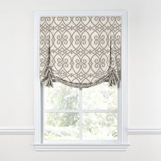 a window with a curtain and valance on it's side, in front of a white wall