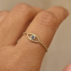 9ct solid gold evil eye ring. The evil eye is handfabricated for recycled 9ct yellow gold. The eye is then bezel set with a 2mm Blue Sapphire.  The ring is available in chain form as shown in photos or as a 1mm plain round band. You can choose your desired option from the drop down menu.  Size: We are a size inclusive brand and all our rings are made to your specific ring size. Please leave your ring size in the message box at checkout. Packaging: We use minimal packaging for our jewellery to re Evil Eye Ring Gold, Minimal Packaging, Ring Sapphire, Evil Eye Ring, Eye Ring, Message Box, Stackable Rings, Ring Box, Evil Eye