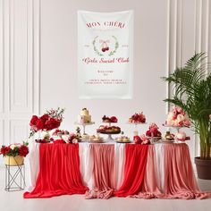 a table topped with cakes and desserts next to a potted plant