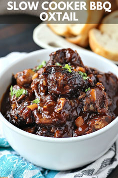 slow cooker bbq oxtail in a white bowl with bread on the side