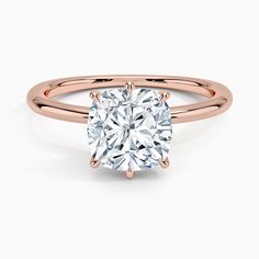 a rose gold engagement ring with a cushion cut diamond